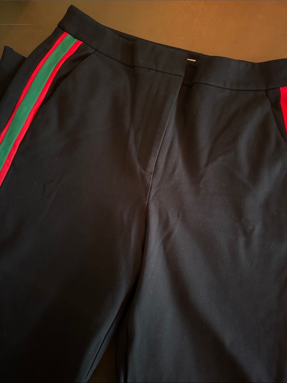 Boden Black Garment with Red and Green Trim. Wide leg with zip ankle detail.